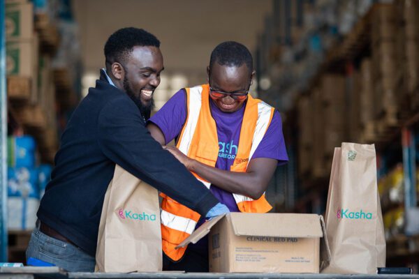 Two employees of Kasha in Kenya packing goods