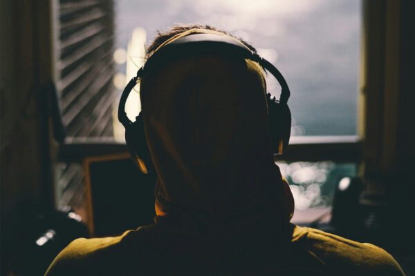 Man wearing headphones looking out of a window