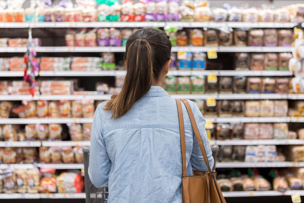 Woman looking at supermarket shelves