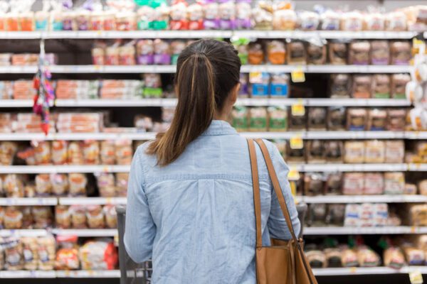 Woman looking at supermarket shelves